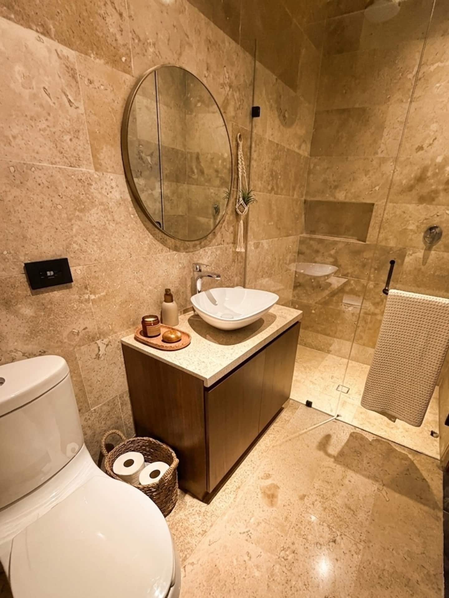 Sala con sofá, televisión y ventanales al jardín